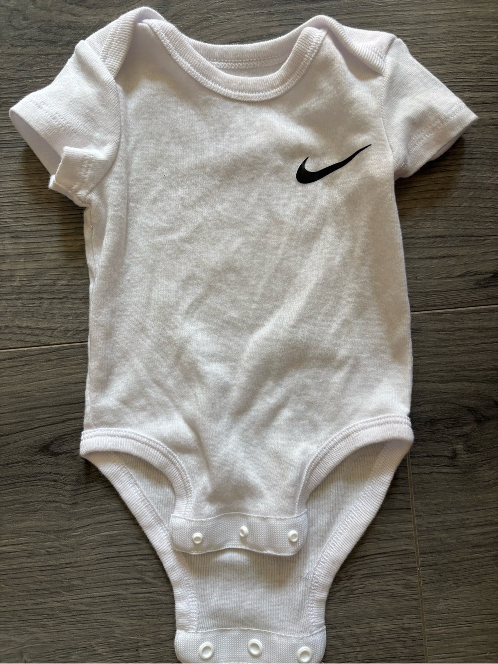 Nike White Infant Bodysuit with Black Swoosh